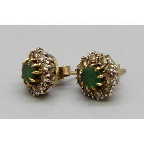 1014 - A pair of yellow metal earrings set with emeralds and white stones, 4.6g