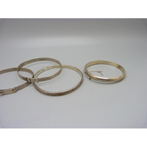 1030 - Five silver bangles including one by Charles Horner, 47g, (some a/f, dents)