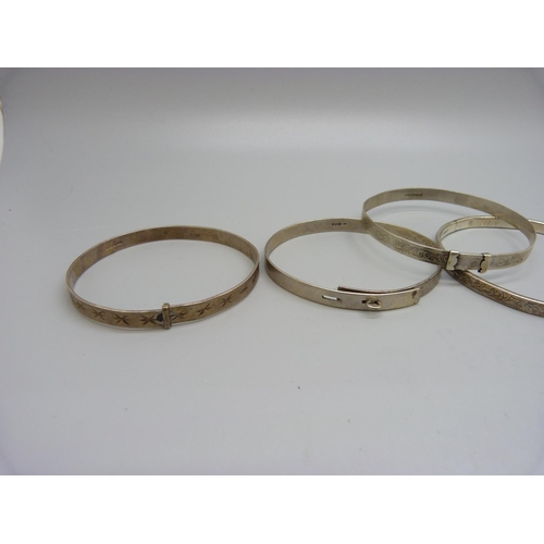 1030 - Five silver bangles including one by Charles Horner, 47g, (some a/f, dents)