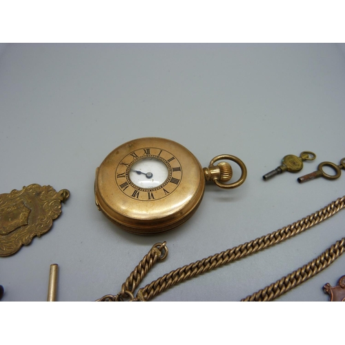 1071 - A gold plated Marvin half-hunter pocket watch, an Albert chain and four fobs