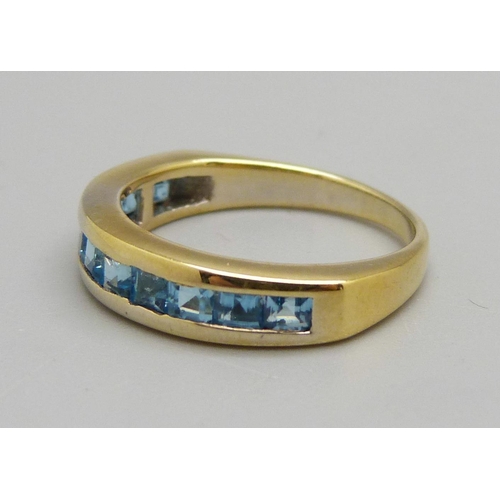 1090 - A silver gilt and blue topaz ring, L