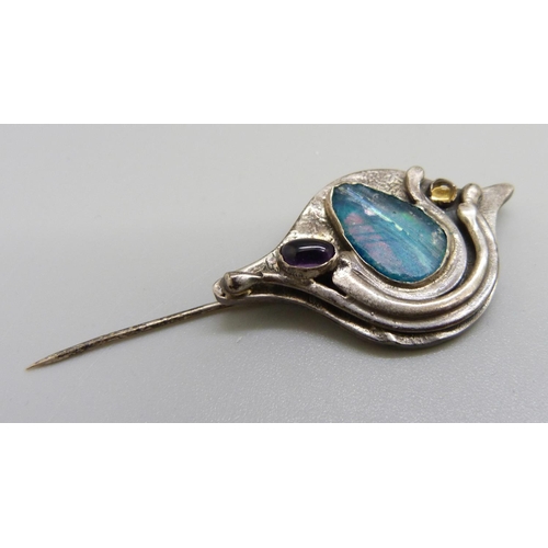 1094 - An oval silver mounted stone set brooch by Charles Horner, a silver mounted brooch with coastal scen... 