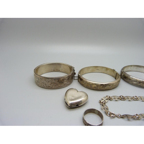 1096 - Three silver bangles, a Victorian silver ring, S, a silver rattle, a/f, and a silver bracelet, 81g