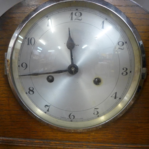 1100 - A 1930's mantle clock, a brass vase and a wall mounted candle holder