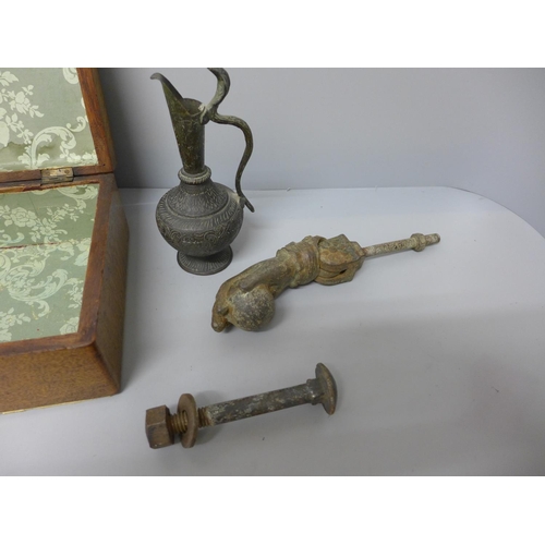 702 - A wooden box containing a 19th Century door knocker and a ewer