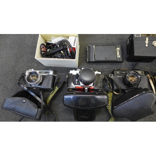 749 - A box of mixed cameras and accessories, including Pentacon, Yashica, Kodak-folding, etc.