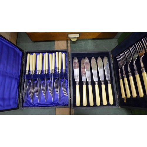 806 - Two cabinets, one wooden, containing a collection of flatware and two boxed sets of fish knives and ... 