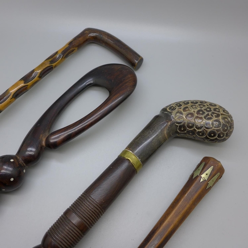 834 - Four walking sticks, one with horn handle and one Persian