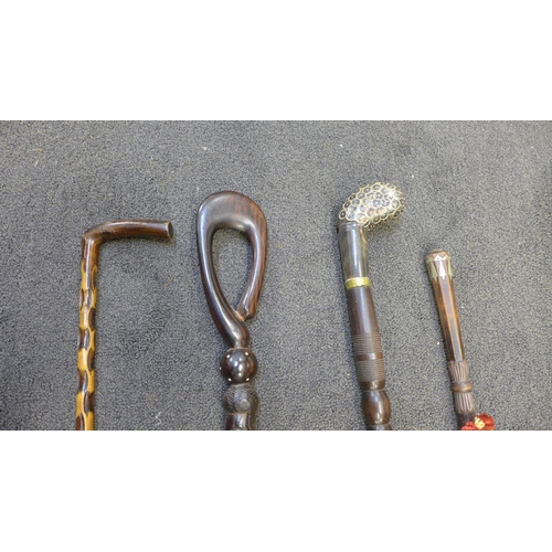 834 - Four walking sticks, one with horn handle and one Persian