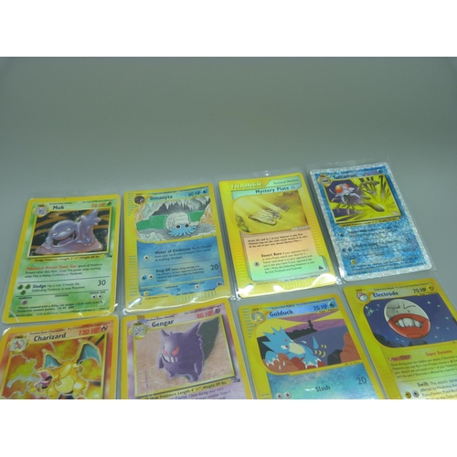 838 - Eleven Pokemon cards including base set 1995-1996 Charizard