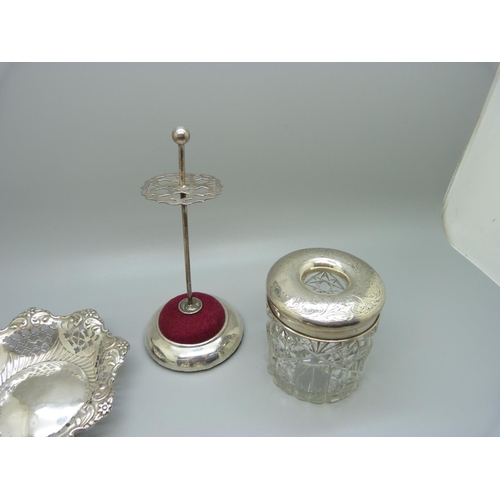 839 - A jewellery stand, a Victorian pierced silver dish, a silver topped glass hair tidy and two silver m... 