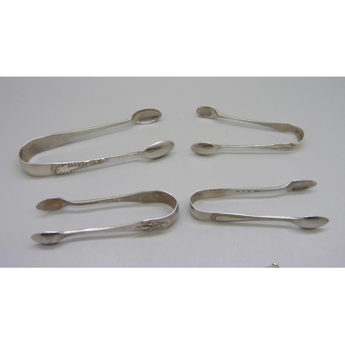 856 - Four pairs of silver sugar bows and two silver mustard spoons including one Victorian, 60g