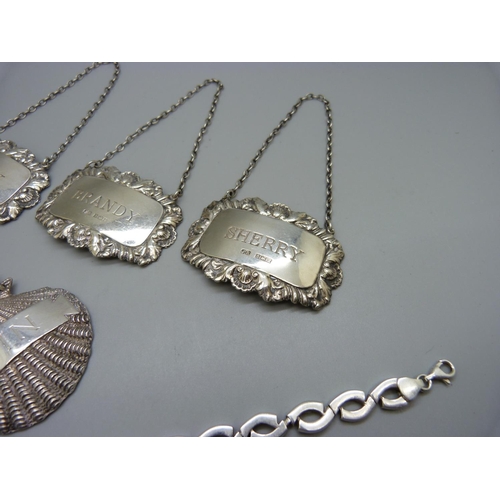 866 - A set of three silver bottle labels, a silver Gin bottle label and a silver bracelet, 106g