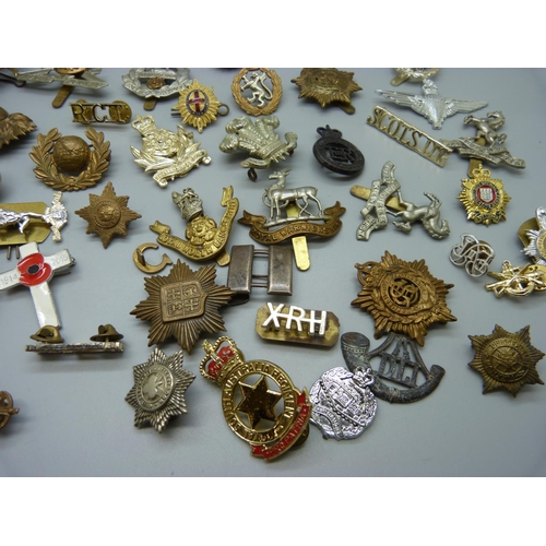 921 - A collection of approximately thirty regimental cap badges