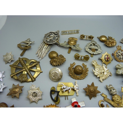 921 - A collection of approximately thirty regimental cap badges