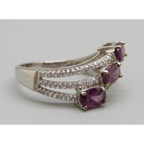 956 - A 9ct white gold magenta garnet and white sapphire ring, 3.5g, S