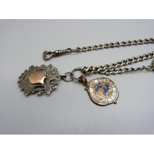 986 - A silver Albert chain with a spinning fob, a silver fob and one other fob