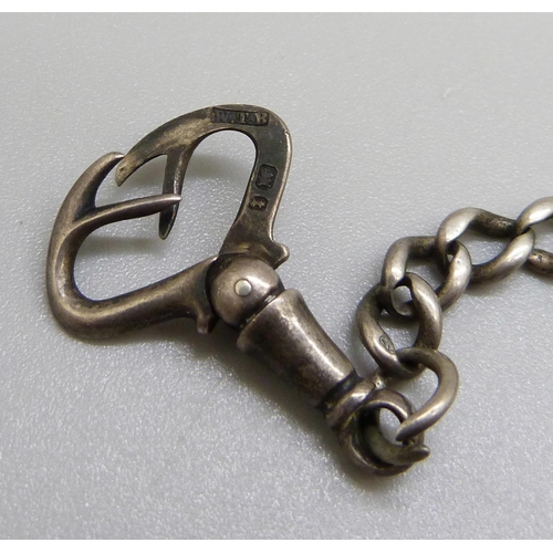 986 - A silver Albert chain with a spinning fob, a silver fob and one other fob