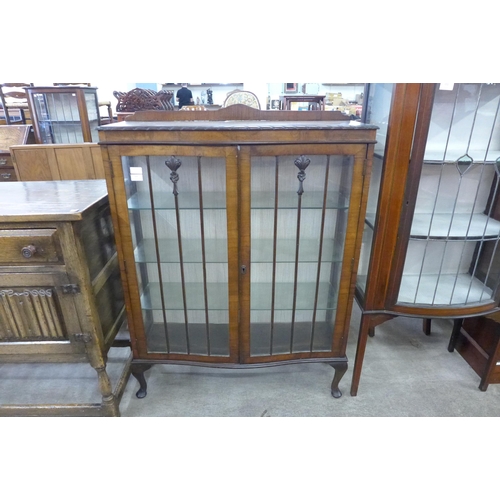 101 - A mahogany serpentine display cabinet