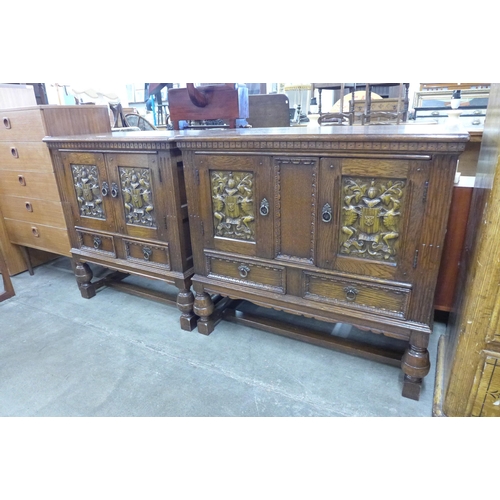 109 - A pair of carved oak armorial credence cupboards