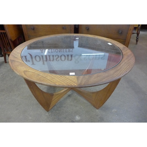 11 - A G-Plan Astro teak and glass topped circular coffee table