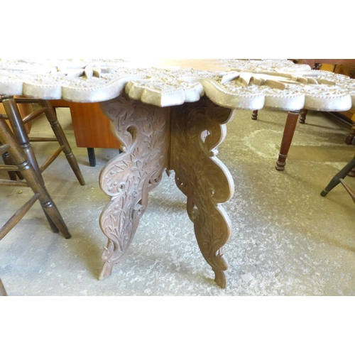 145 - An eastern carved hardwood occasional table