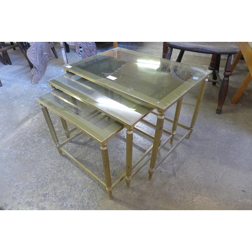 147 - An Italian brass and glass topped nest of tables