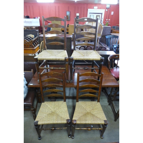 207 - A set of four George III style elm and beech ladderback chairs