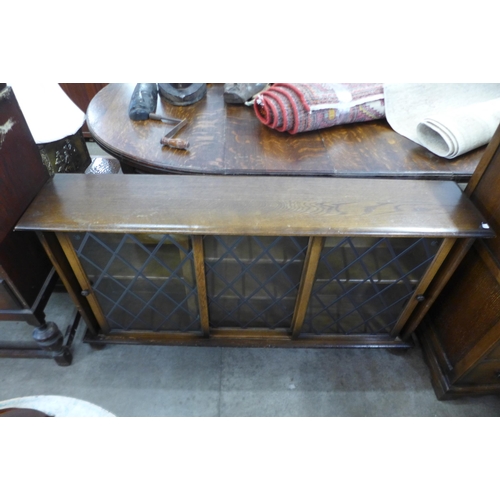 226 - An oak bookcase and a carved oak chest of drawers