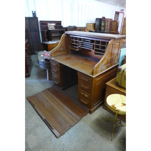 233 - An early 20th Century walnut tambour roll top desk