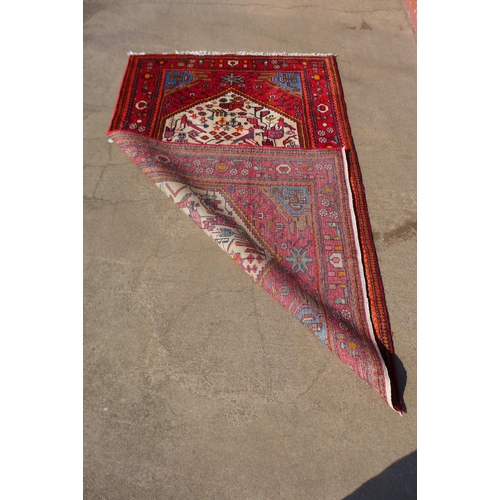 236 - An Iranian hand knotted red ground rug