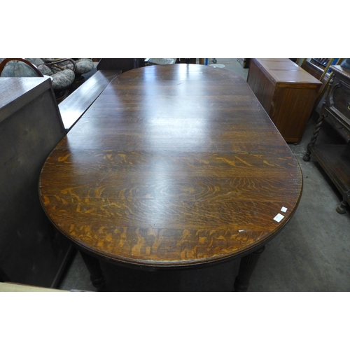 240 - A Victorian oak extending dining table