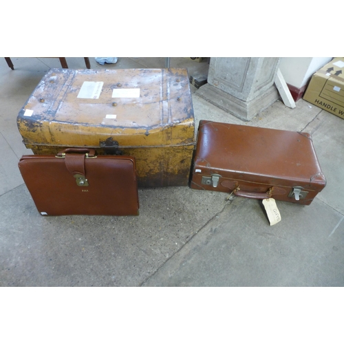 255 - A tin steamer trunk, a leather case and a satchel