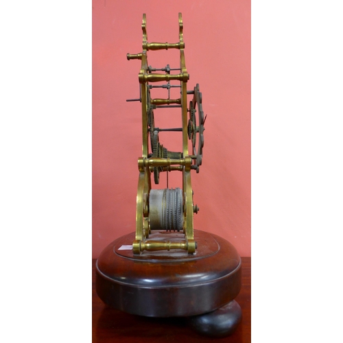 313 - An early Victorian brass skeleton clock, on mahogany base