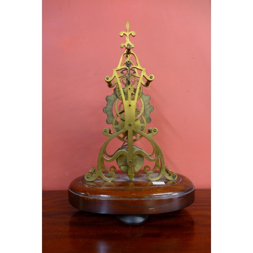 313 - An early Victorian brass skeleton clock, on mahogany base