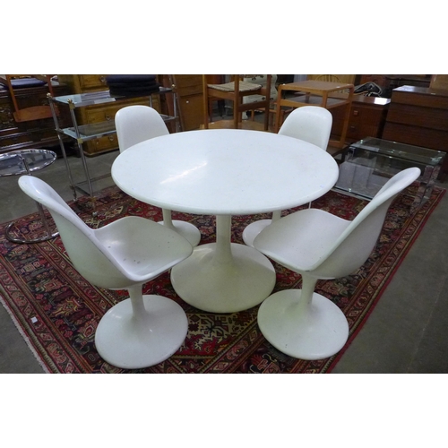 38 - An Arkana style white laminate tulip shaped dining table and four chairs