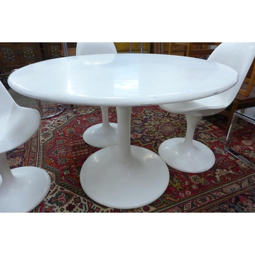 38 - An Arkana style white laminate tulip shaped dining table and four chairs