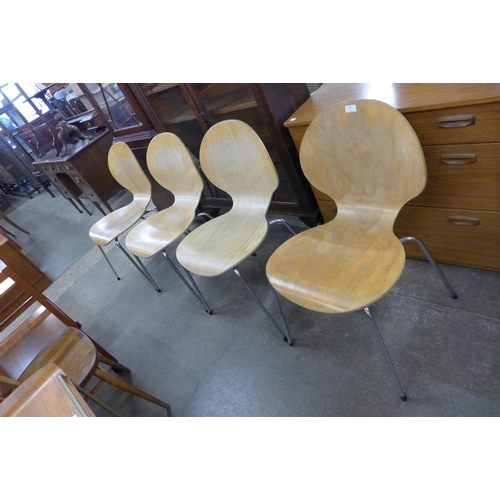 56 - A set of four bent plywood and chrome stacking chairs