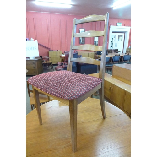 63 - A teak extending dining table and four G-Plan teak dining chairs