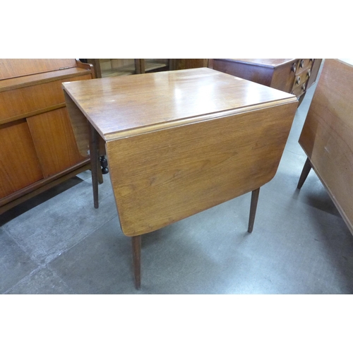 64 - A teak drop-leaf table and four chairs