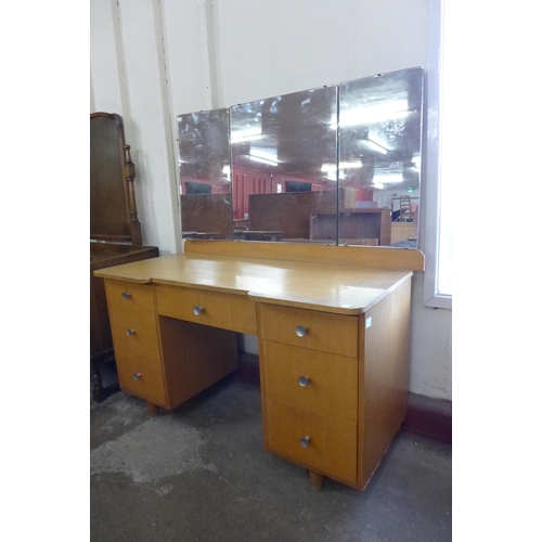 67 - A teak bookcase, a teak trolley, a dressing table and a coffee table with matching occasional table