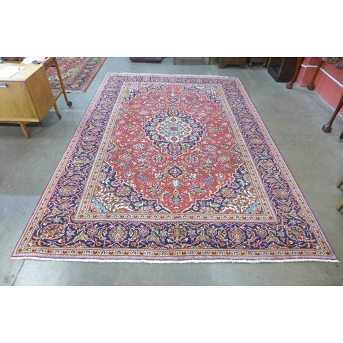 71 - A Persian red ground Kashan rug, 363 x 249cms