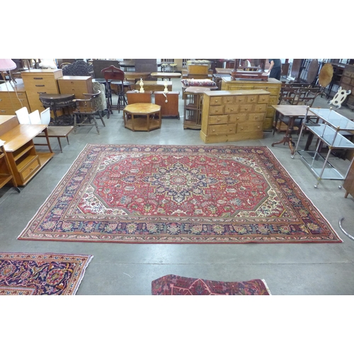 73 - A Persian red ground Tabriz rug, 346 x 250cms