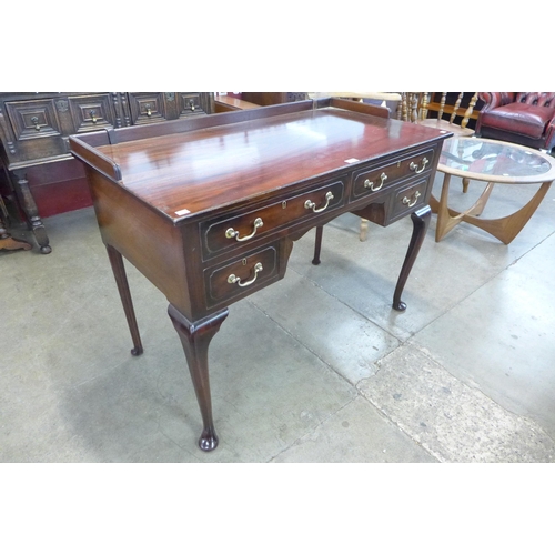 80 - An Edward VII mahogany four drawer writing table