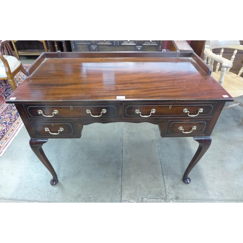 80 - An Edward VII mahogany four drawer writing table