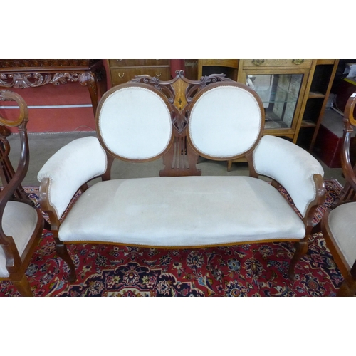 81 - An Art Nouveau inlaid mahogany seven piece salon suite