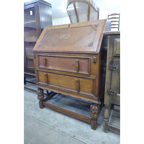 98 - An early 20th Century carved oak bureau