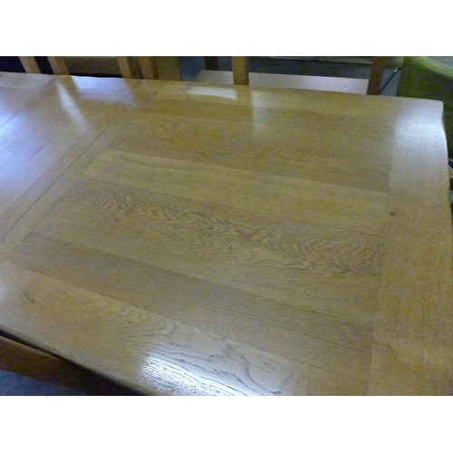 1541 - An oak extending dining table and twelve chairs