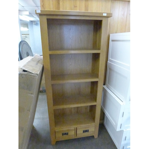 1518 - A tall oak bookcase with drawer base