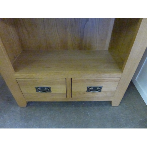 1518 - A tall oak bookcase with drawer base